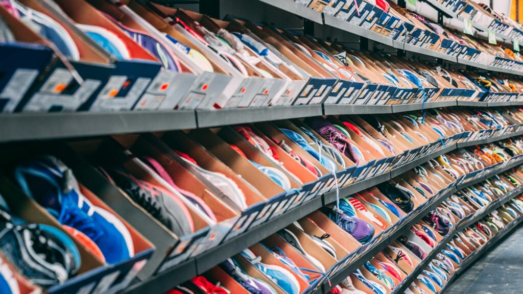 A vibrant display of various sneakers on shelves in a shoe store, showcasing styles and options.